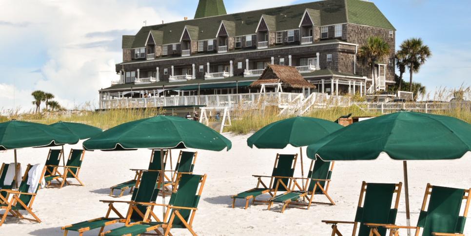 White sand and green beach chairs beside the Gulf in Destin